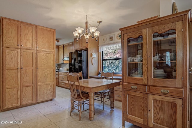 tiled dining room with an inviting chandelier