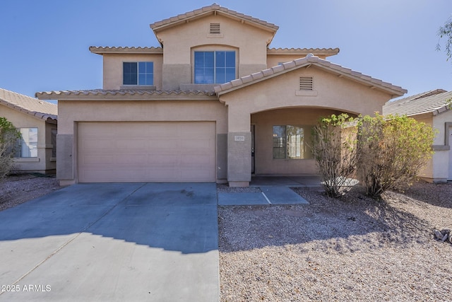9939 W Southgate Ave, Tolleson, AZ 85353 - mediterranean / spanish house featuring a garage, driveway, and stucco siding