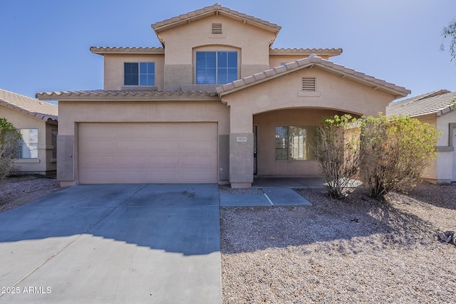 mediterranean / spanish house featuring a garage, driveway, and stucco siding