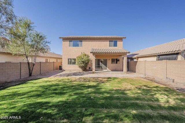 back of property featuring a yard, a patio, a fenced backyard, and stucco siding