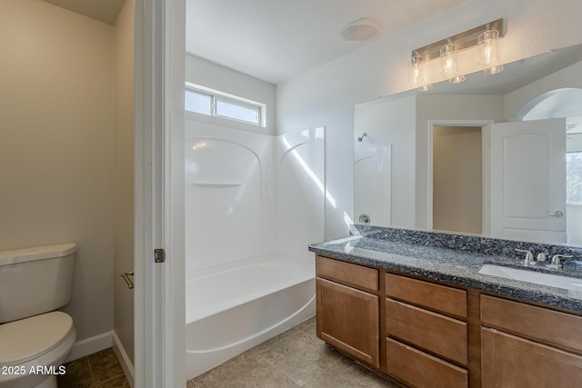 full bathroom featuring vanity, toilet, baseboards, and shower / washtub combination