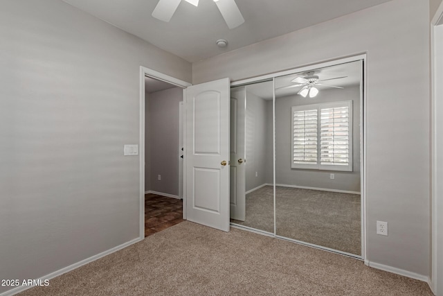 unfurnished bedroom featuring a ceiling fan, carpet, a closet, and baseboards