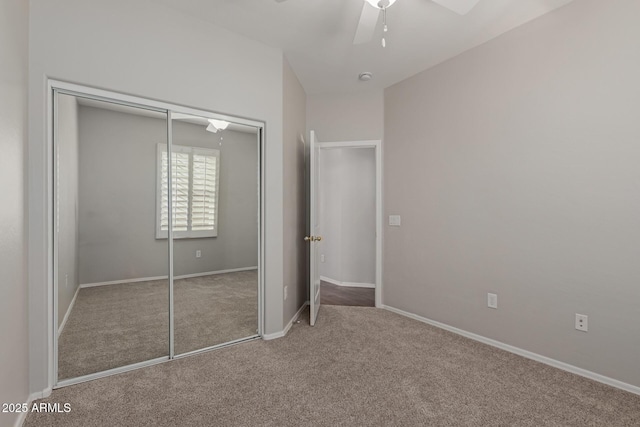 unfurnished bedroom featuring a closet, baseboards, ceiling fan, and carpet flooring