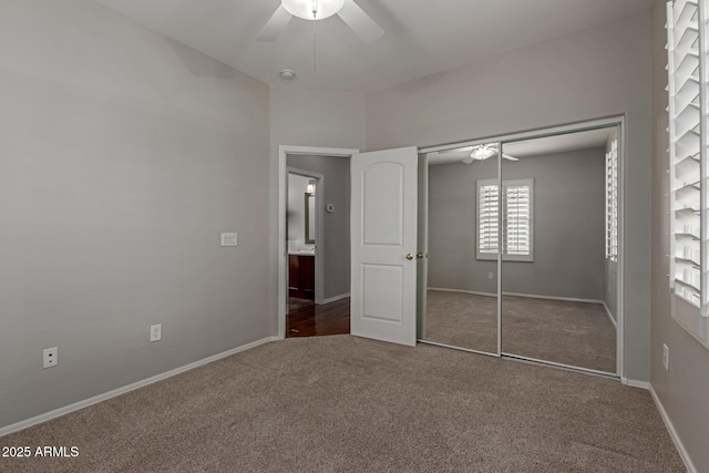 unfurnished bedroom with a closet, baseboards, carpet, and a ceiling fan