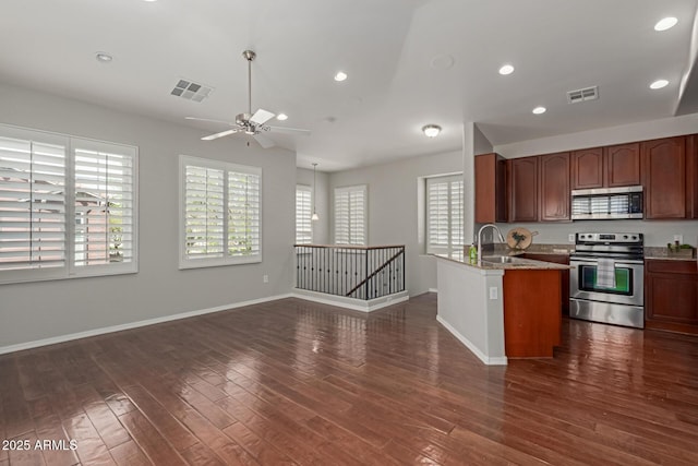 kitchen featuring visible vents, a healthy amount of sunlight, appliances with stainless steel finishes, and dark wood-style flooring