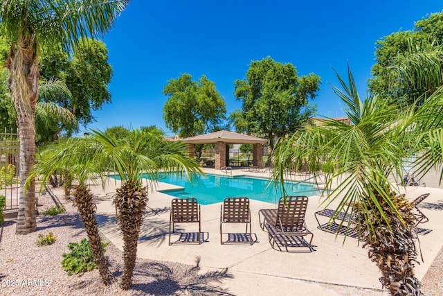 pool featuring a patio area and fence