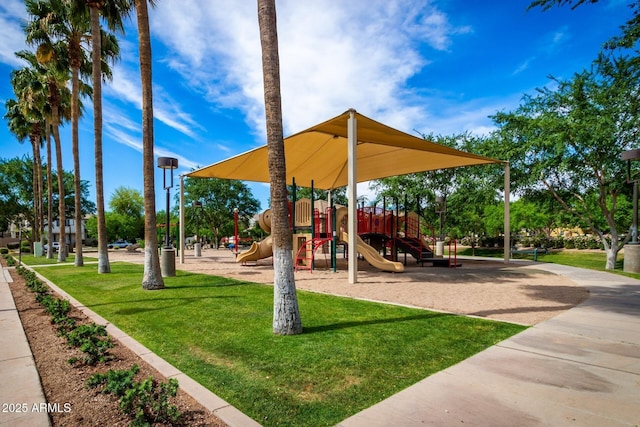 community jungle gym featuring a lawn