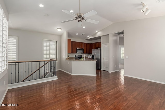 kitchen featuring a ceiling fan, visible vents, dark wood finished floors, lofted ceiling, and stainless steel appliances