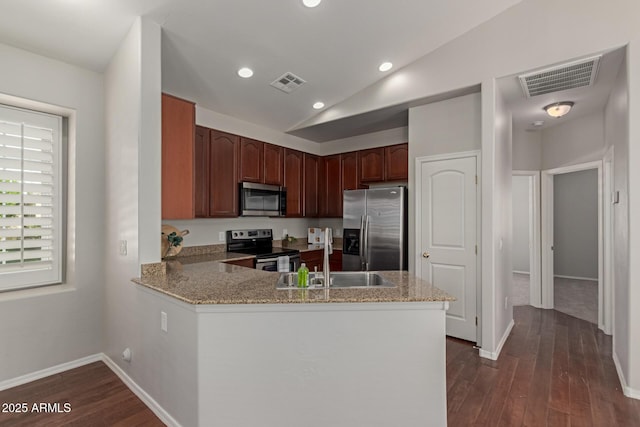 kitchen featuring a sink, stainless steel appliances, visible vents, and dark wood-style flooring