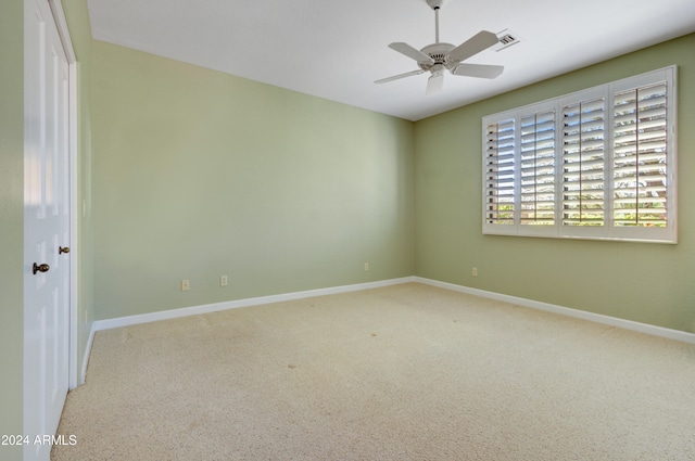 empty room with carpet floors and ceiling fan