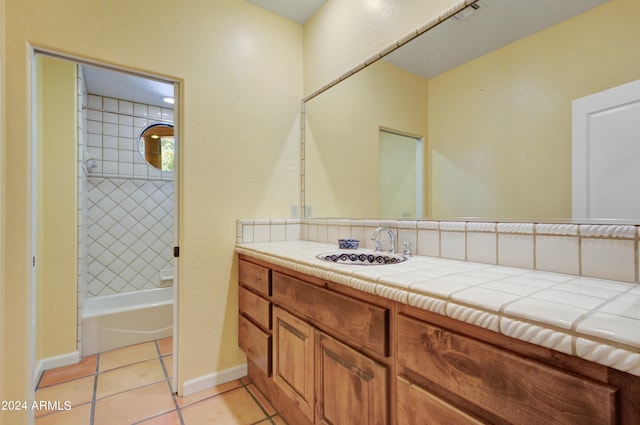 bathroom featuring vanity, tiled shower / bath, and tile patterned floors