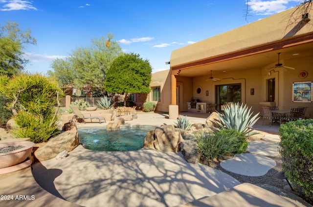 view of swimming pool featuring a patio and ceiling fan