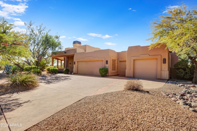 southwest-style home featuring a garage