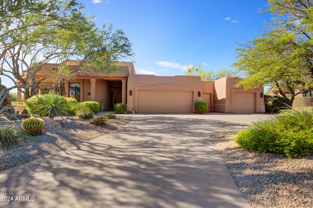 southwest-style home with a garage