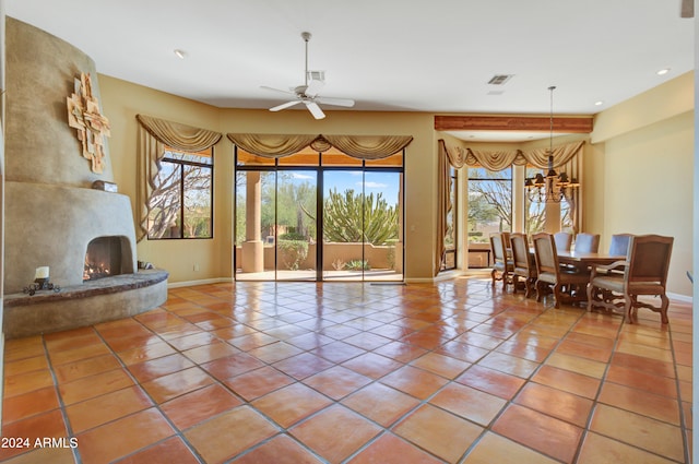 tiled living room featuring ceiling fan and a premium fireplace