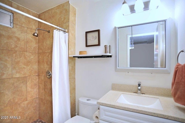 full bath with vanity, toilet, and tiled shower