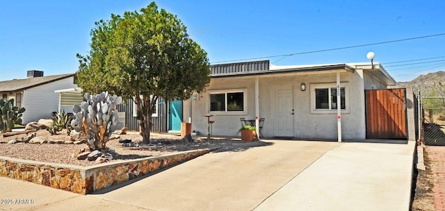 view of front of home featuring a gate and stucco siding