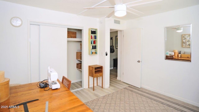 bedroom with visible vents, a closet, light wood-style floors, baseboards, and a ceiling fan