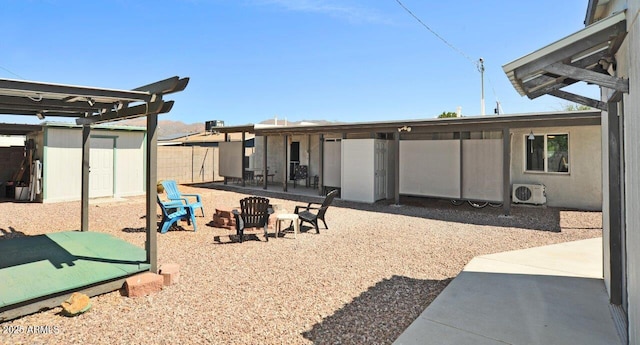 back of property featuring ac unit, a patio area, fence, an outdoor structure, and a shed