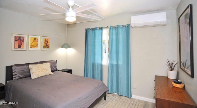 bedroom with baseboards, a wall unit AC, and a ceiling fan
