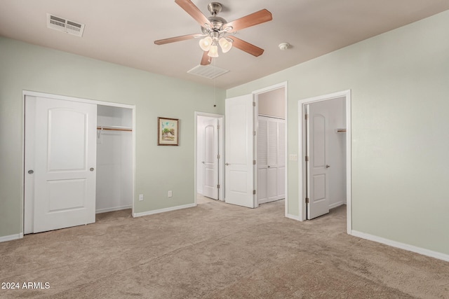 unfurnished bedroom with ceiling fan and light colored carpet