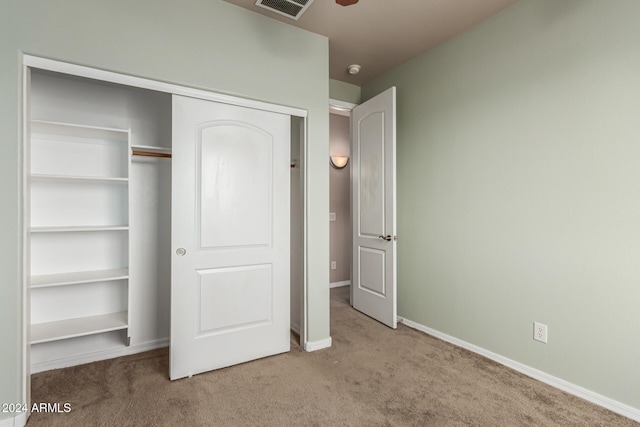 unfurnished bedroom with carpet flooring and a closet