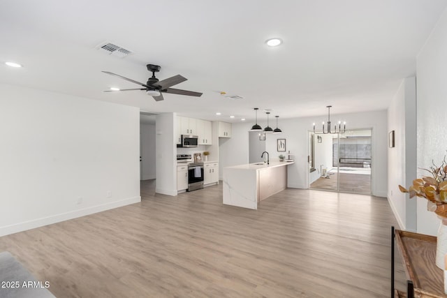3008 S Saguaro Cir, Mesa, AZ 85202 - unfurnished living room with a sink, a chandelier, recessed lighting, light wood-style floors, and ceiling fan