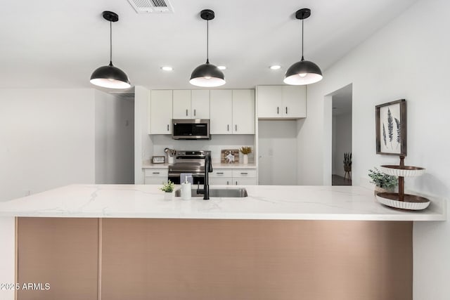 3008 S Saguaro Cir, Mesa, AZ 85202 - kitchen with appliances with stainless steel finishes, white cabinets, recessed lighting, light stone countertops, and a peninsula