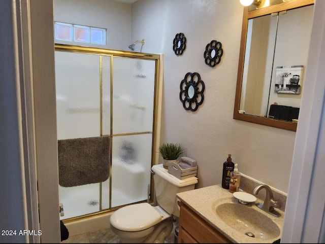 bathroom with walk in shower, vanity, and toilet