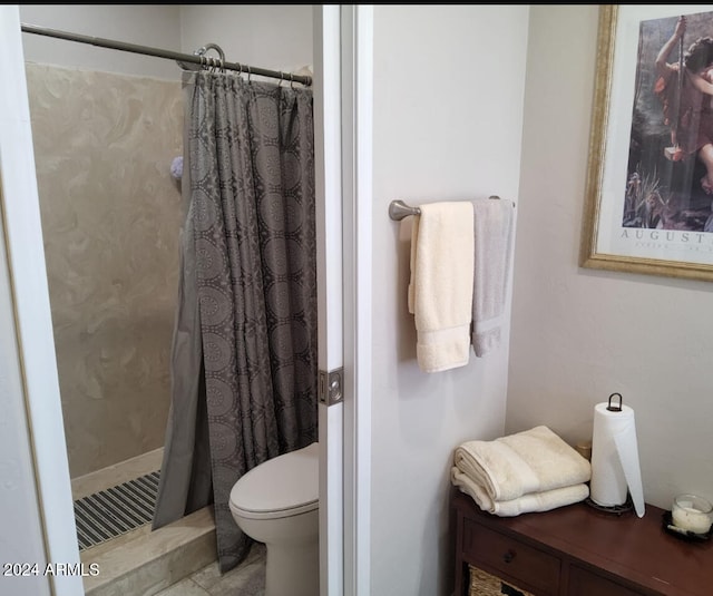 bathroom featuring walk in shower and toilet