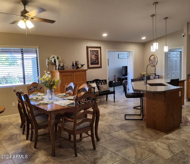 dining space featuring sink and ceiling fan