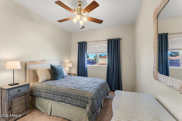 carpeted bedroom with multiple windows and ceiling fan