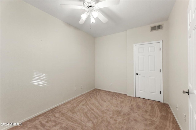 spare room with light carpet and ceiling fan