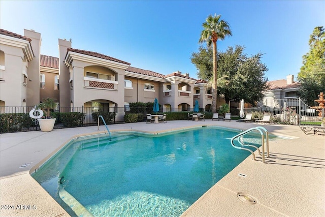 view of swimming pool featuring a patio area