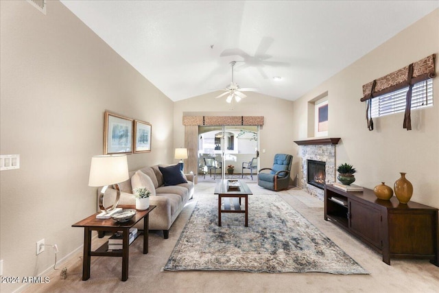 living room featuring a fireplace, light carpet, plenty of natural light, and lofted ceiling