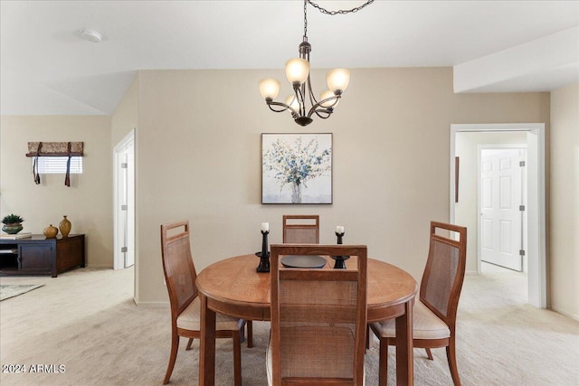 dining room with a notable chandelier and light carpet