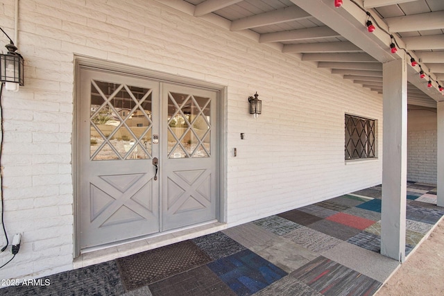 view of exterior entry featuring french doors