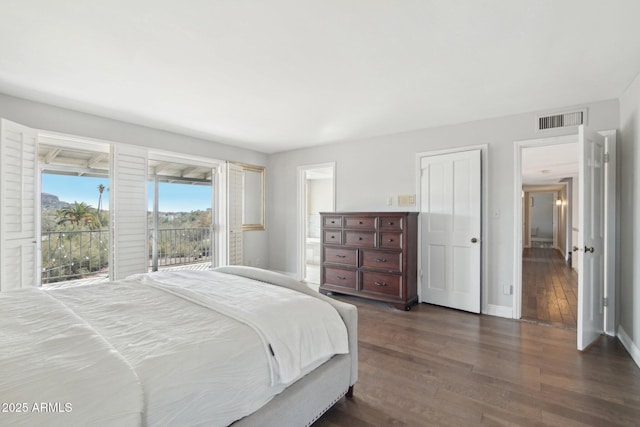 bedroom featuring dark wood-type flooring and access to outside