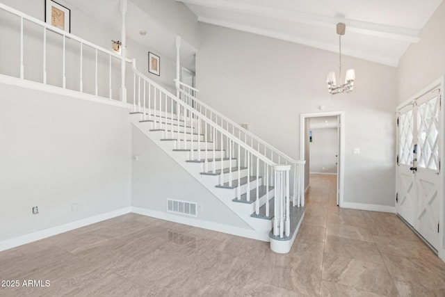 foyer entrance with a notable chandelier, beam ceiling, and high vaulted ceiling