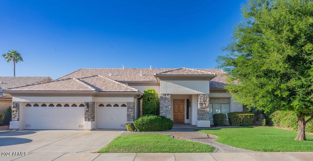 view of front of property with a front yard and a garage