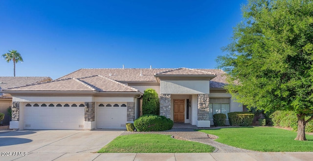 view of front of property with a front yard and a garage