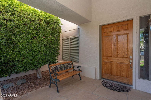 view of exterior entry with a porch