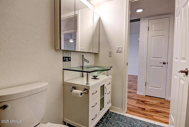 bathroom featuring sink, tile patterned floors, and toilet