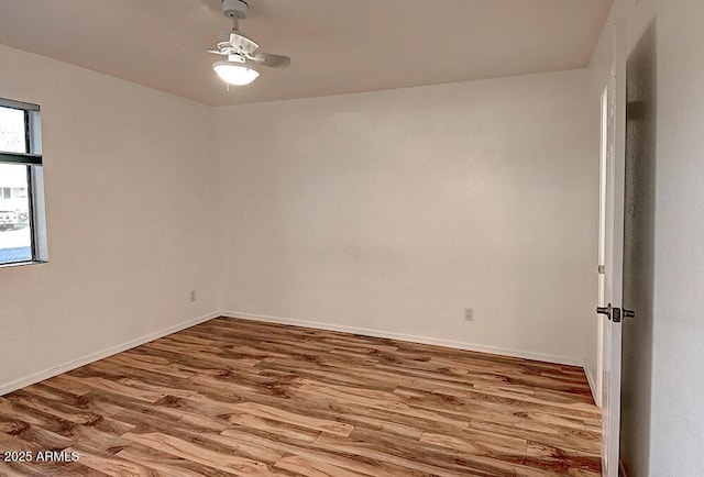 spare room featuring hardwood / wood-style flooring and ceiling fan