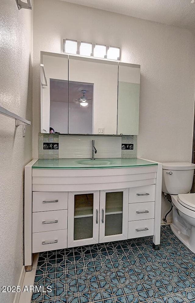 bathroom with tile patterned floors, vanity, and toilet