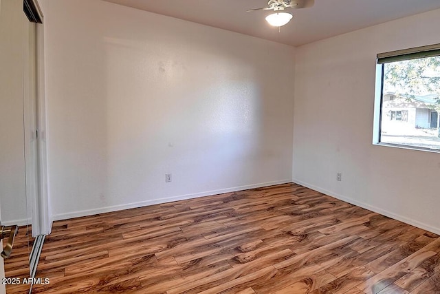 empty room featuring ceiling fan and hardwood / wood-style floors