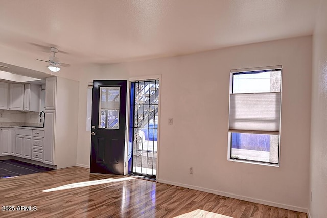 entrance foyer with dark hardwood / wood-style floors, sink, and ceiling fan