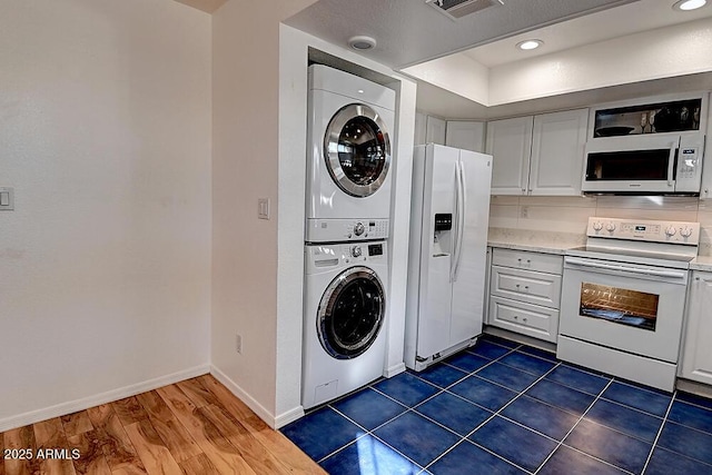 laundry room featuring stacked washer / dryer