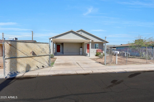 view of front of home with a gate, a carport, driveway, and fence