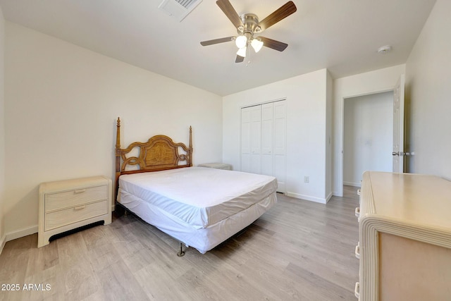 bedroom featuring baseboards, visible vents, ceiling fan, a closet, and light wood-type flooring